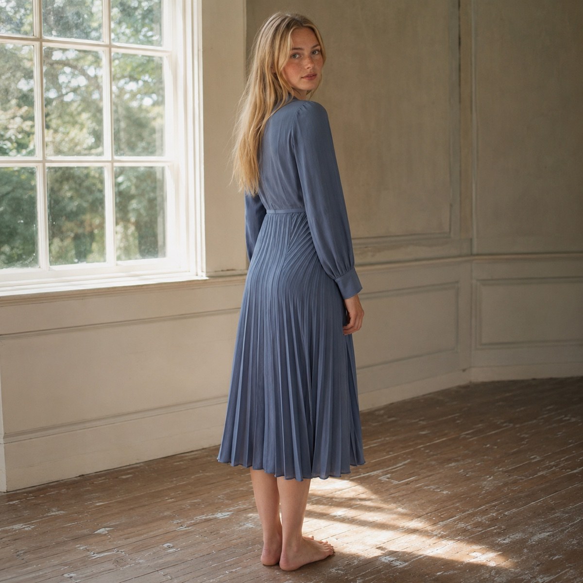 Bromley Vale sunray-pleat midi dress — Pleated Midi Dresses by ORASCI. worn by a model, side view.