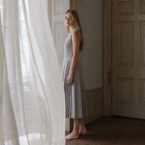 Hazel Court knife-pleat midi dress — Pleated Midi Dresses by ORASCI. worn by a model.