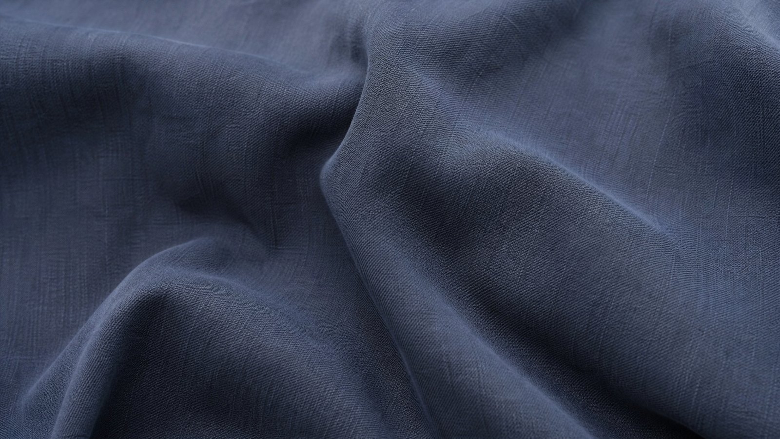 Close detail of overlapping charcoal ribbed and oatmeal cable knitted fabric